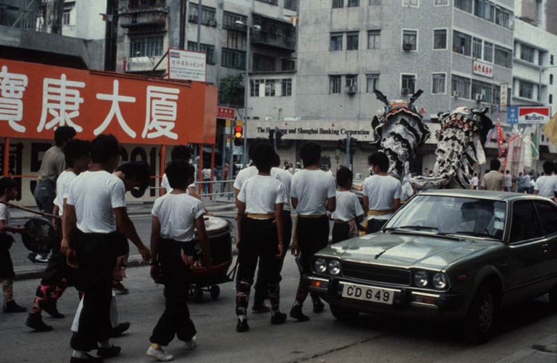 The dance troop moves down the street